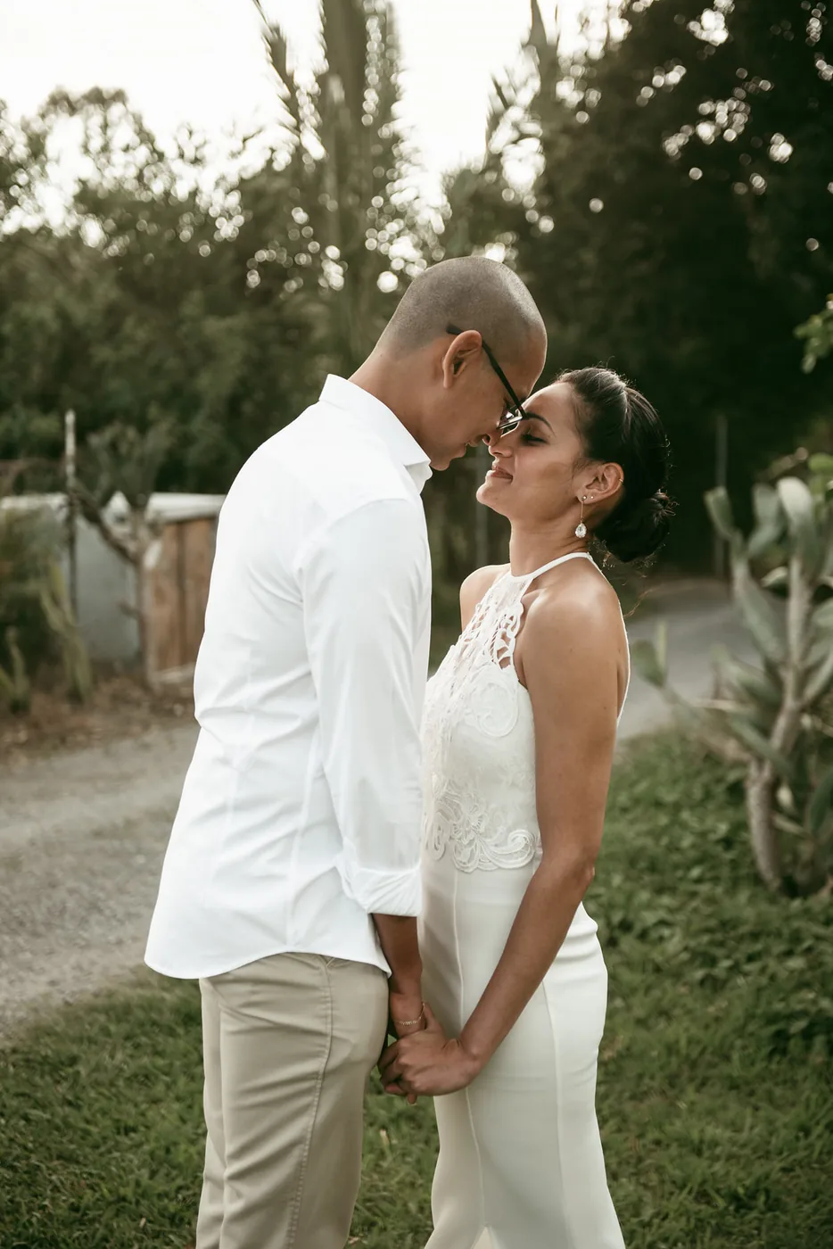 Couple in white clothing holding hands on a tropical Mauritius beach