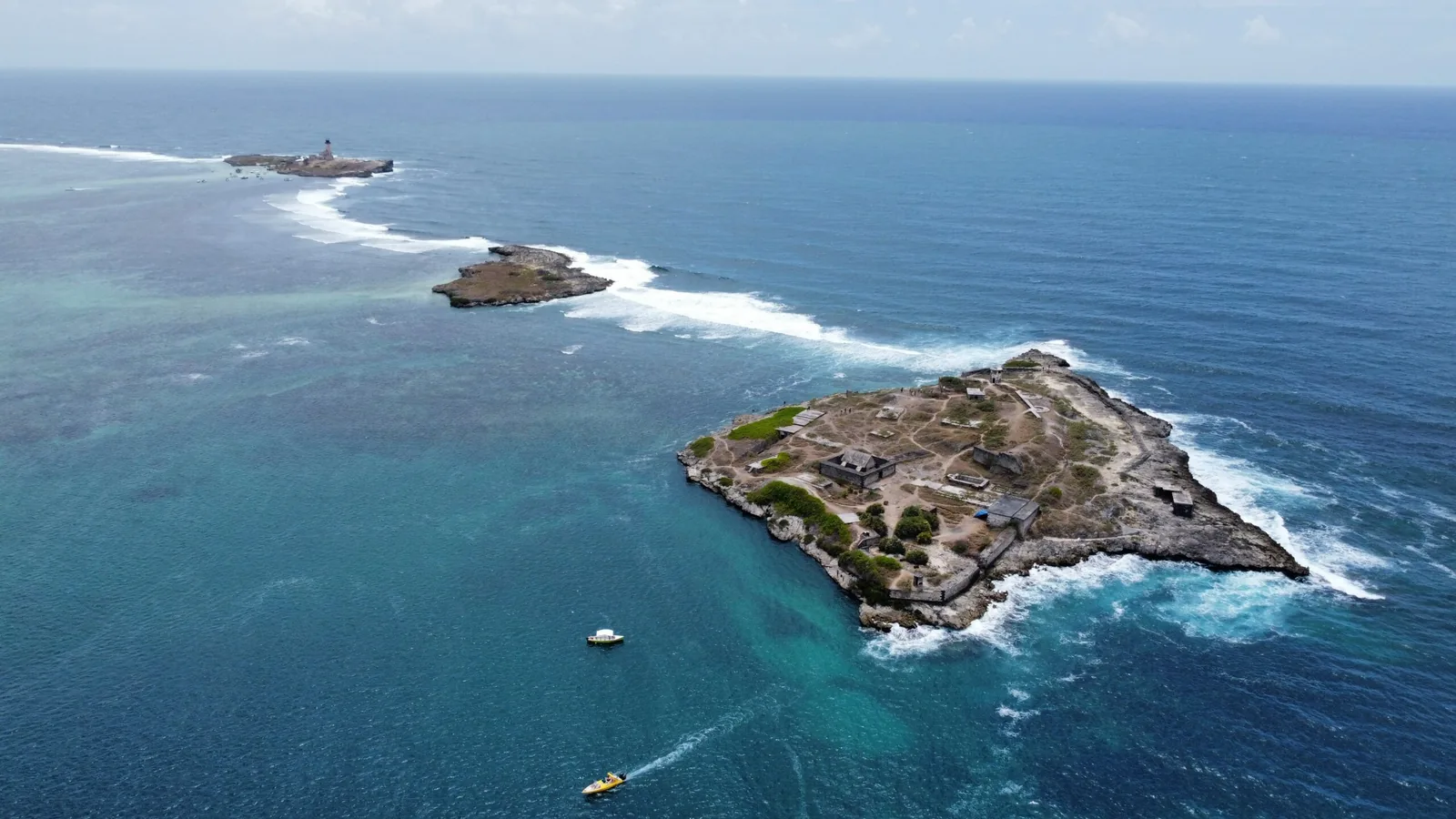 Aerial drone view of small offshore tropical islands and clear blue water in Mauritius