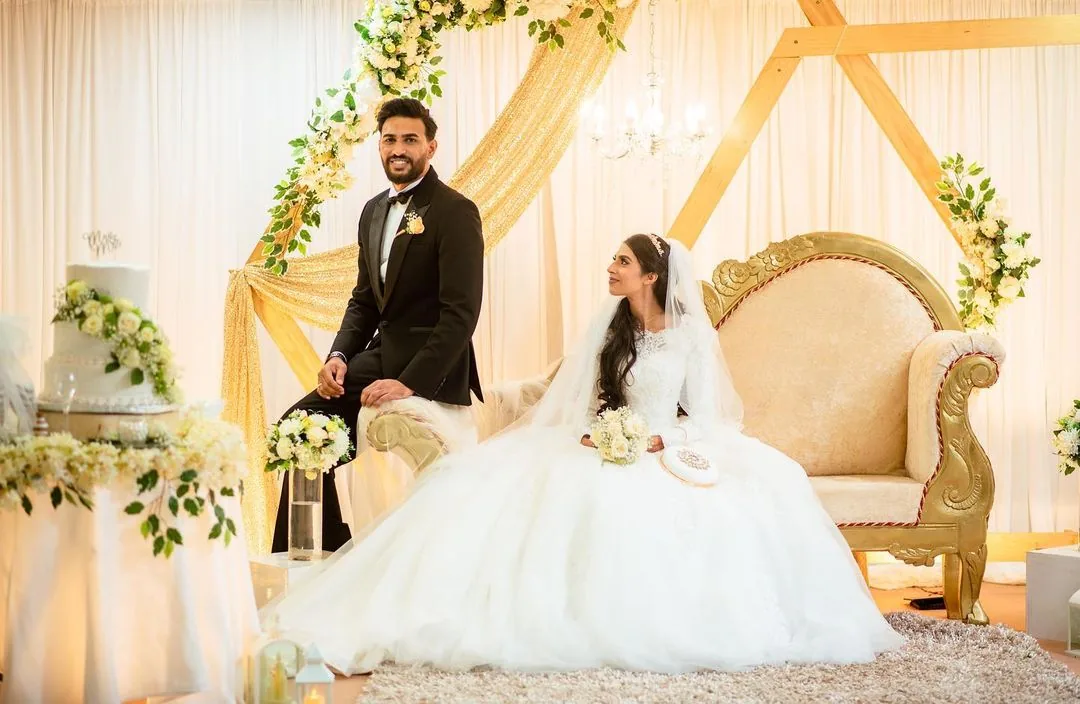 Bride and groom in ornate traditional attire seated together at a Mauritius wedding reception