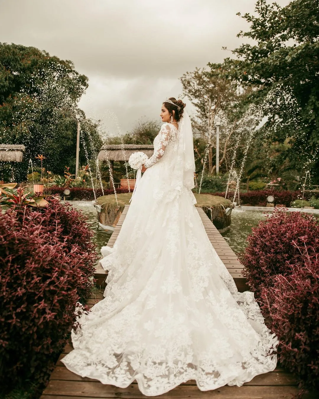 Bride in delicate white lace gown posing during a wedding session in Mauritius
