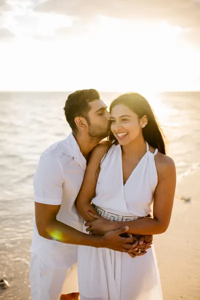 Couple embracing beach sunset, Mauritius