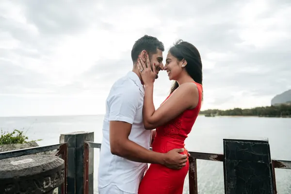 Couple embracing near ocean under, Mauritius