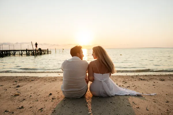 Couple sitting together sandy beach, Mauritius