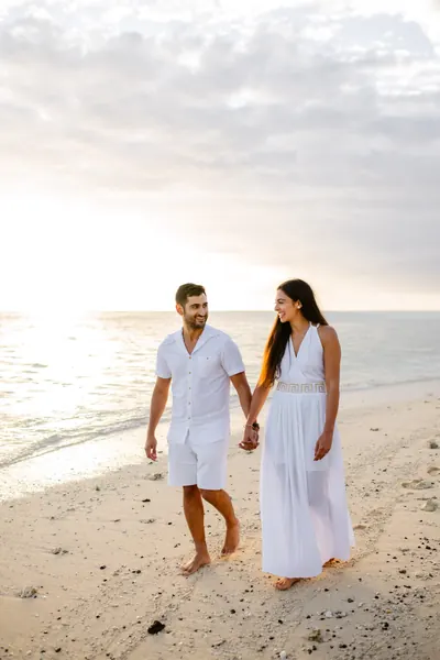 Couple walking hand hand along, Mauritius