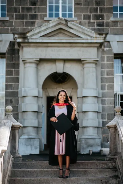 Graduate outside historic stone building, Mauritius