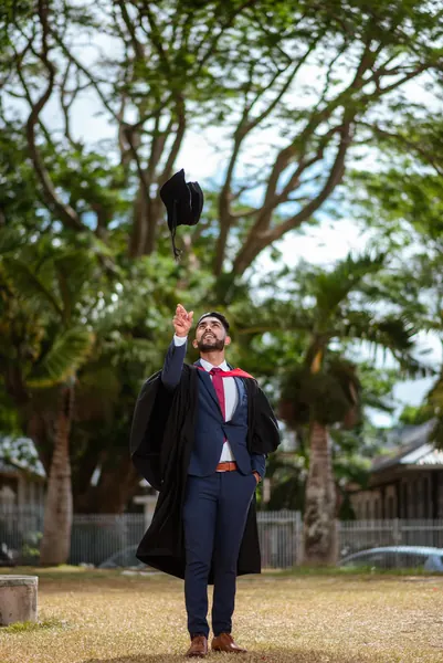 Graduate throwing cap into air, Mauritius
