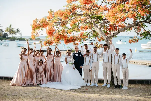 Bridal party posing near water, Mauritius